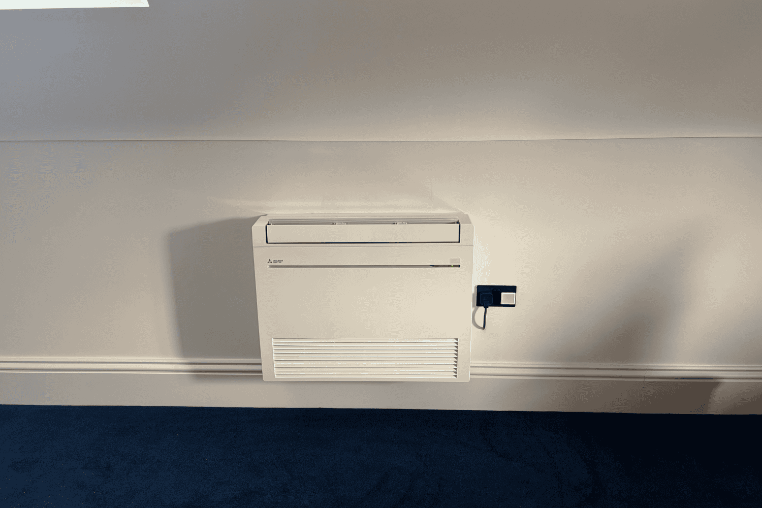 Floor standing air conditioning unit installed in a loft space, Guildford